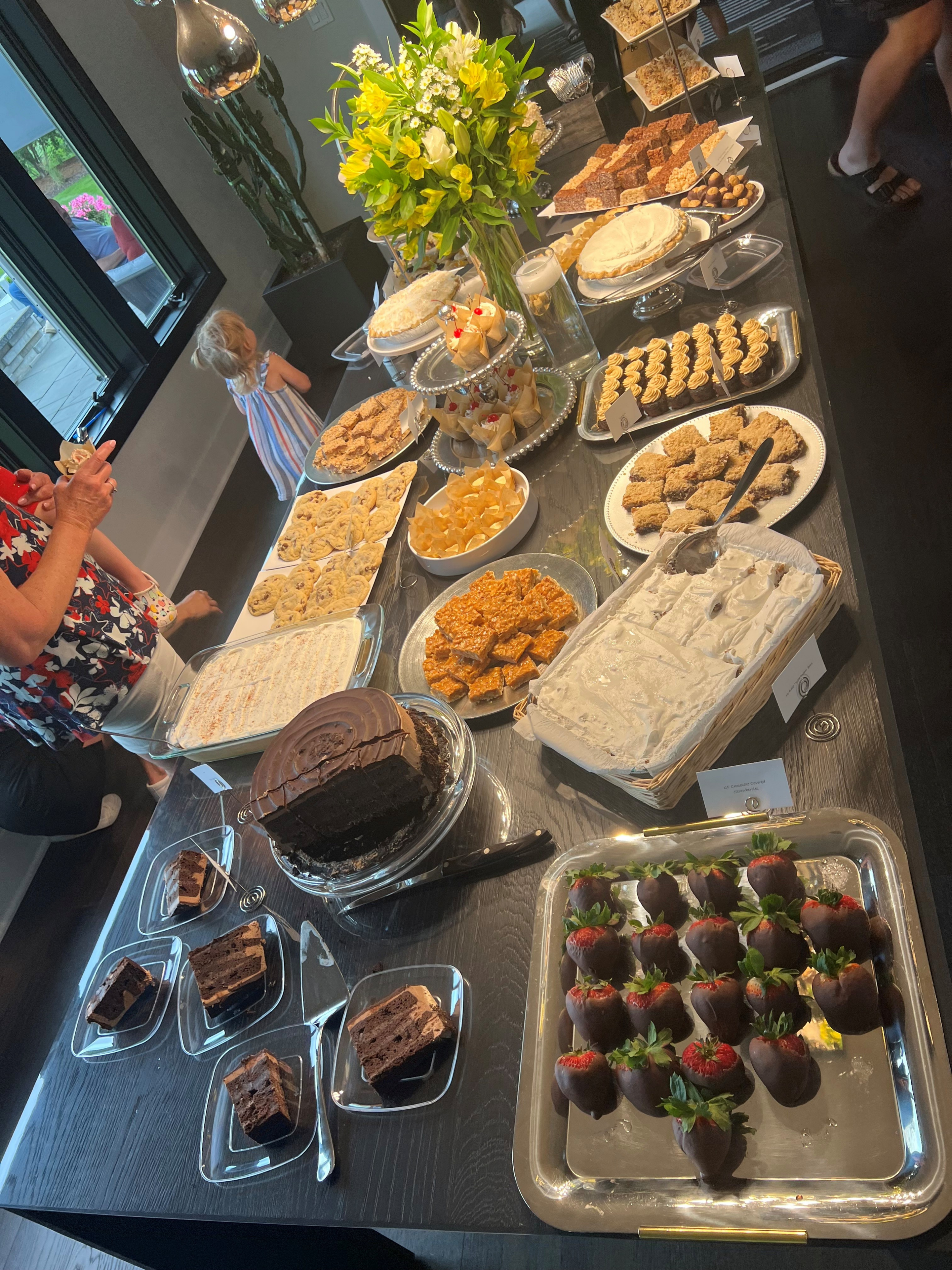 Dessert buffet table with various sweet treats.