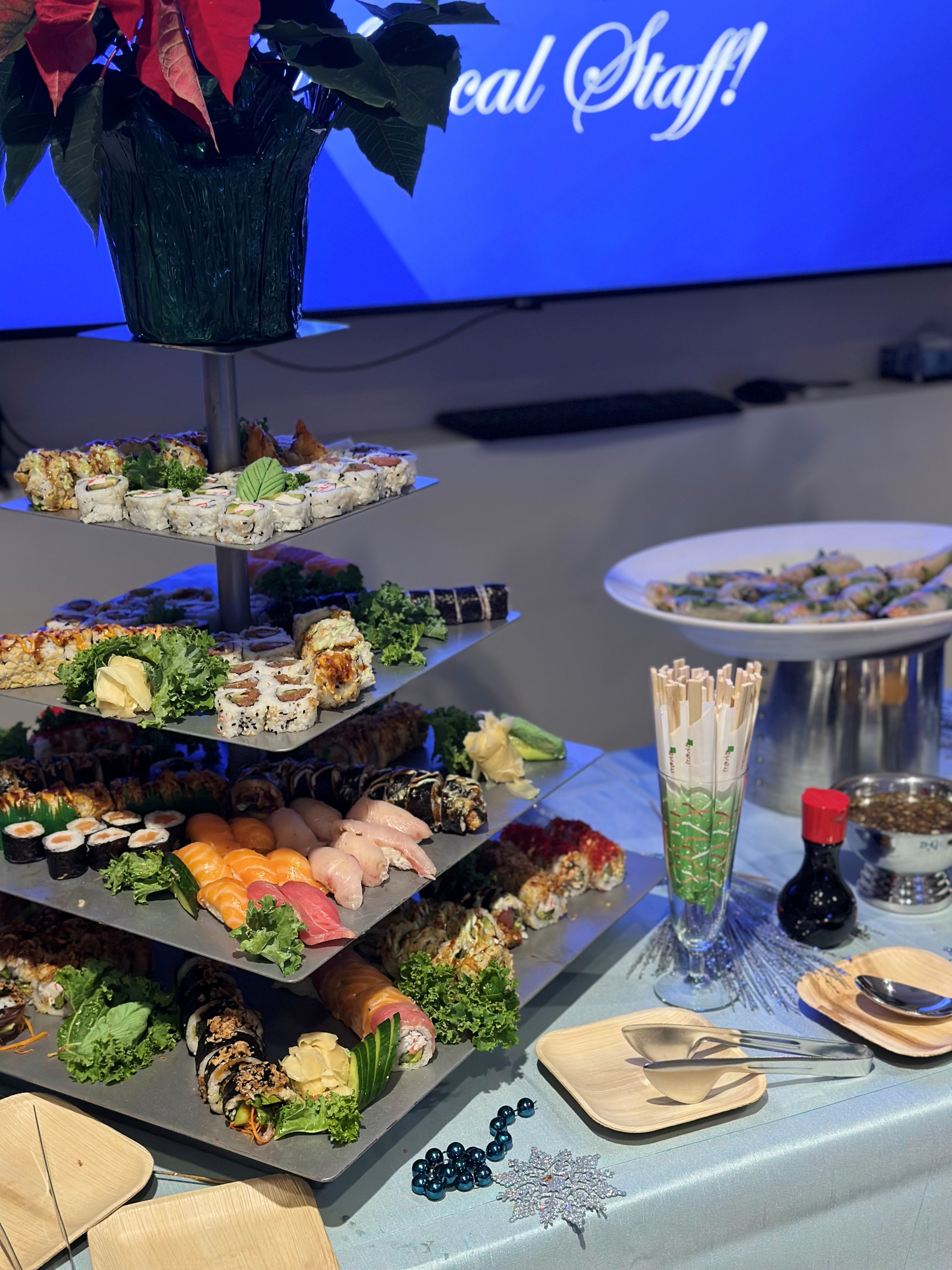 Sushi assortment on tiered serving platter.