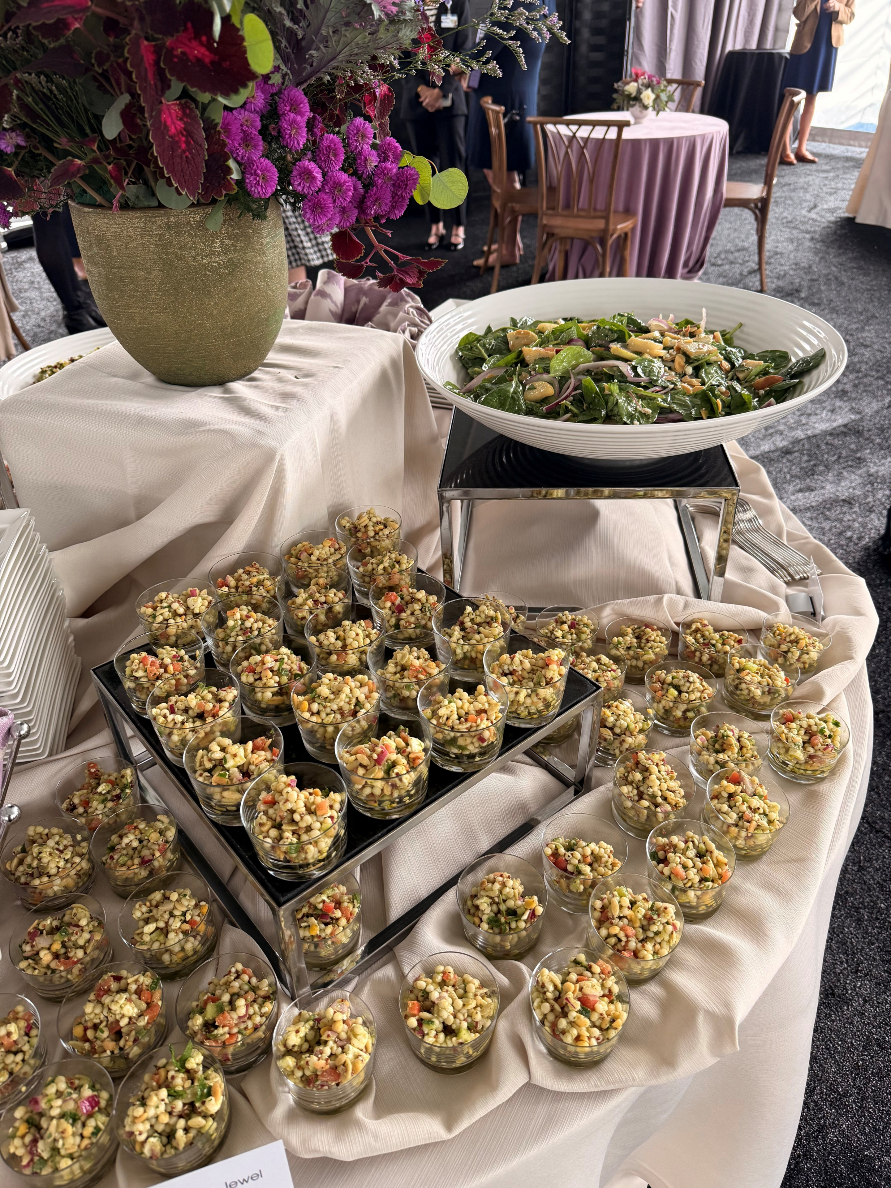 Buffet table with salads and flowers arrangement.