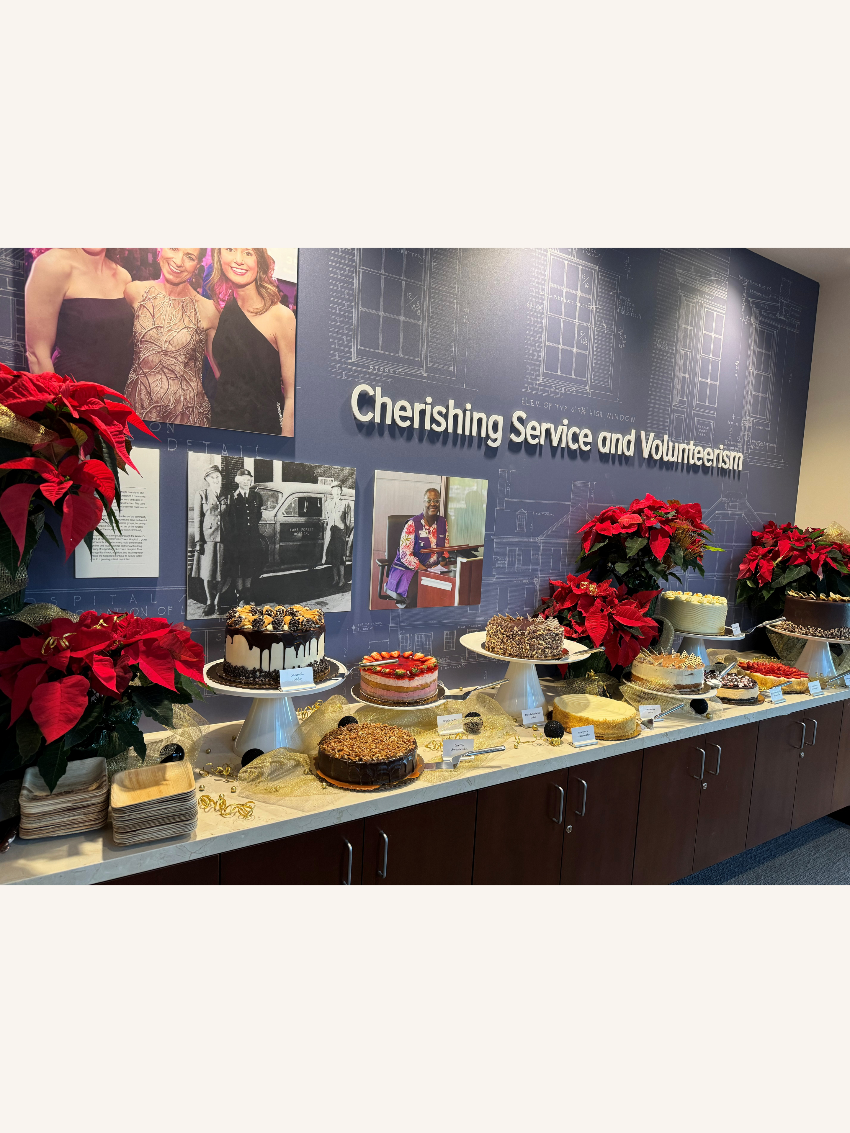 Dessert table with poinsettias and photos displayed.